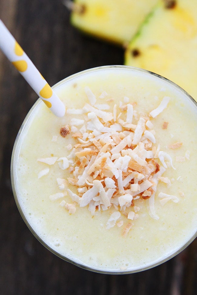 Pineapple Coconut Smoothie in a glass with a straw