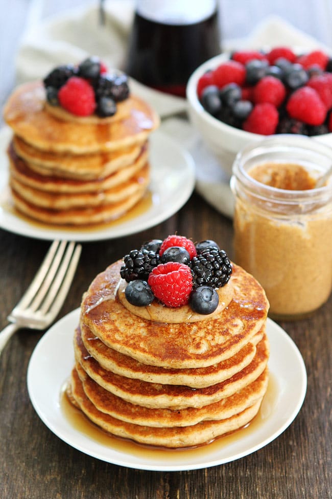 Almond Butter Pancakes with berries, almond butter, and maple syrup