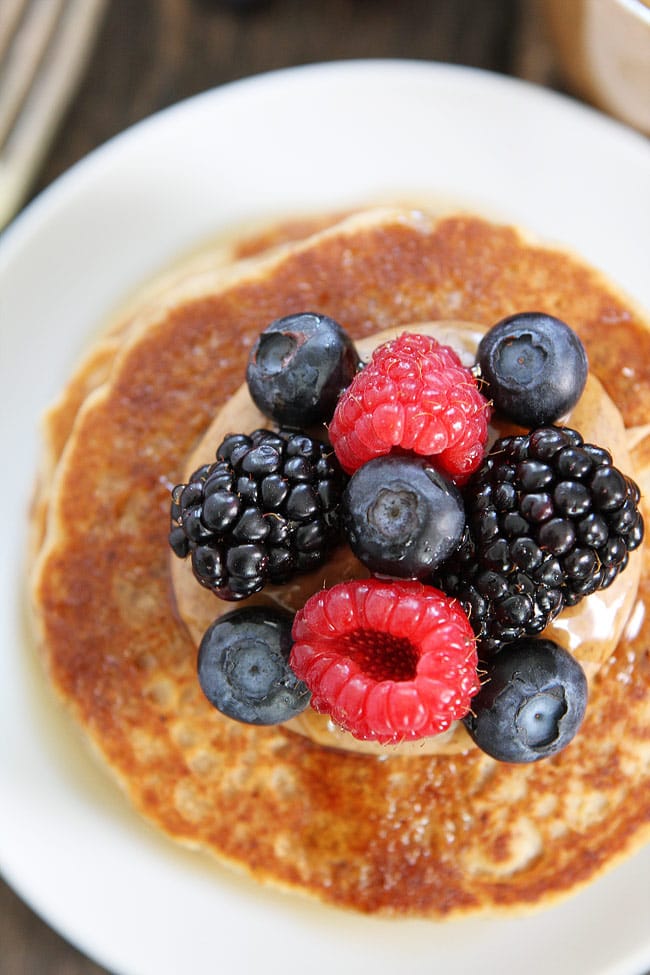 Almond Butter Pancakes with berries on plate with fork