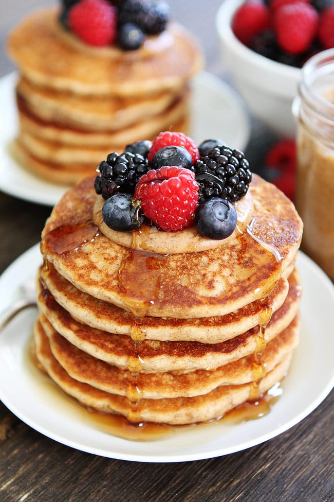 Stack of Almond Butter Pancakes  with berries and syrup