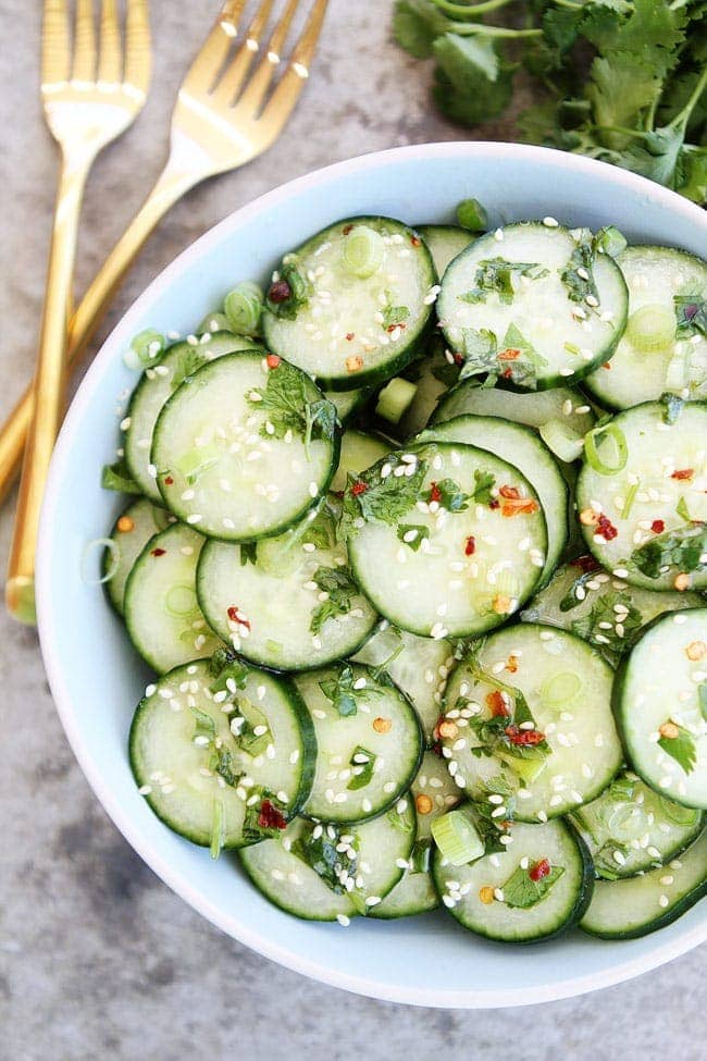 Asian Cucumber Salad with sesame seeds in white serving dish