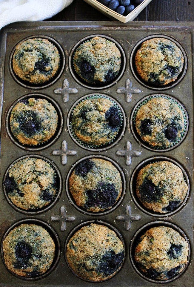 Zucchini Banana Blueberry Muffin Recipe on twopeasandtheirpod.com Use your summer zucchini to make these nutritious and delicious muffins! They are easy to make and freeze beautifully! Zucchini Banana Blueberry Muffins in muffin pan.