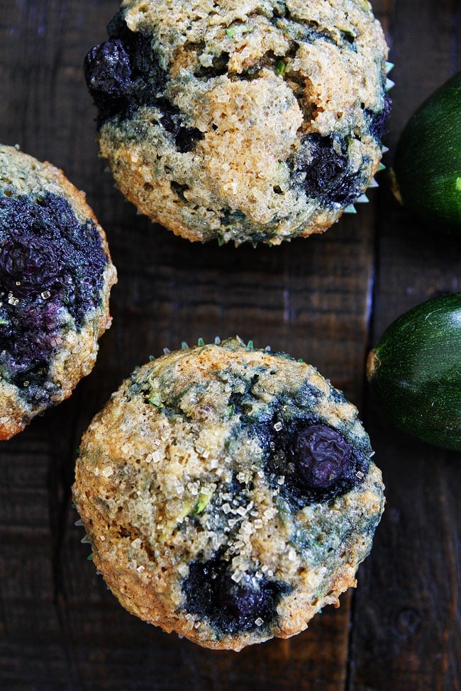 Zucchini Banana Blueberry Muffins on wood table.