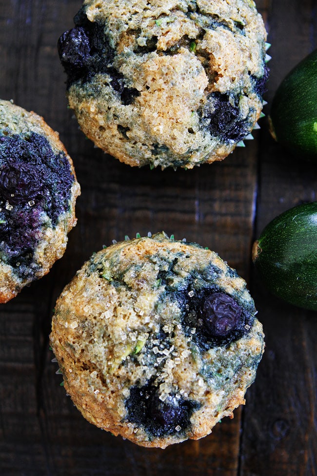 Zucchini Banana Blueberry Muffin Recipe on twopeasandtheirpod.com Use your summer zucchini to make these nutritious and delicious muffins! They are easy to make and freeze beautifully! Zucchini Banana Blueberry Muffins on wood table.