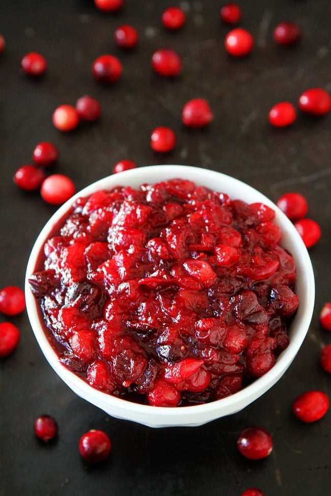 cranberry sauce in white bowl with fresh cranberries. 