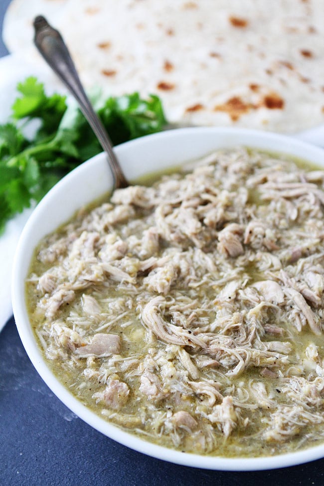 chicken chile verde in bowl ready to serve with tortillas