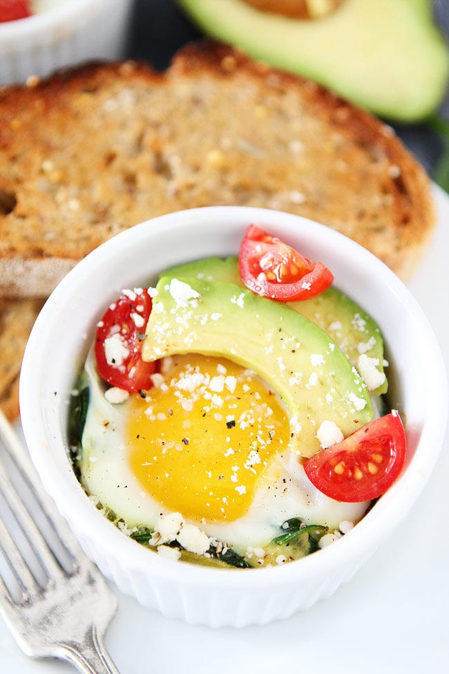 Ramekin of baked spinach and eggs with feta, avocado, and tomato