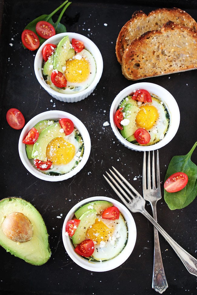 Baked Spinach and Eggs topped with avocado and tomato with toast