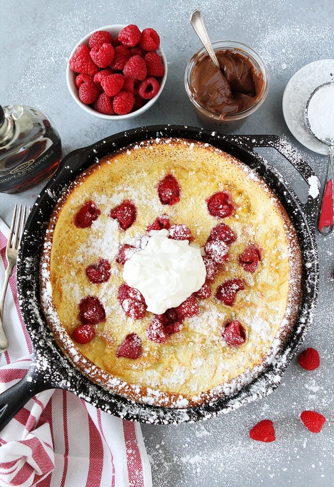 Dutch Baby Pancake in skillet with ingredients and toppings