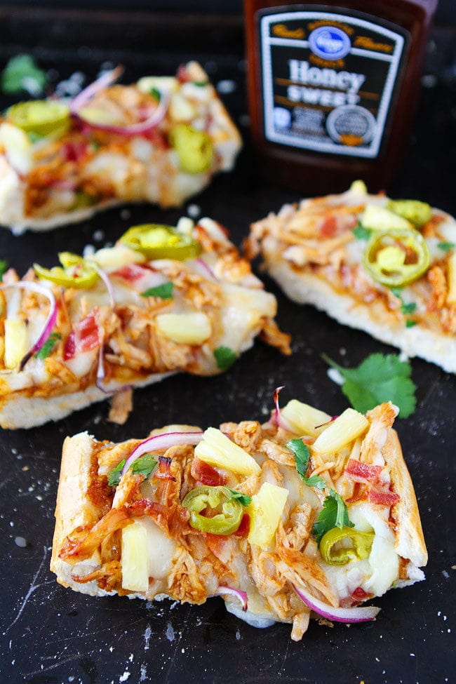 BBQ Chicken French Bread Pizza made with store-bought French bread and topped with BBQ sauce, chicken, bacon, mozzarella cheese, pineapple, jalapeño, and cilantro. This easy pizza is a favorite weeknight dinner.