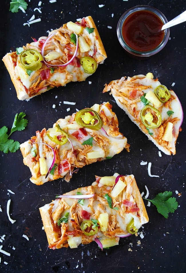 BBQ Chicken French Bread Pizza made with store-bought French bread and topped with BBQ sauce, chicken, bacon, mozzarella cheese, pineapple, jalapeño, and cilantro. This easy pizza is a family favorite meal.