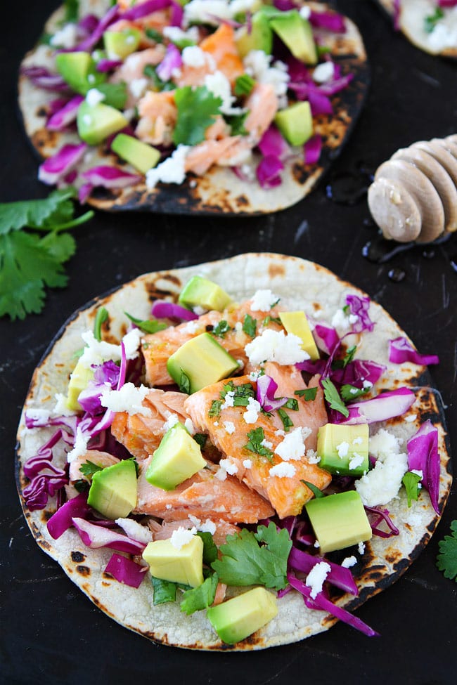 Healthy salmon fish tacos piled with veggies