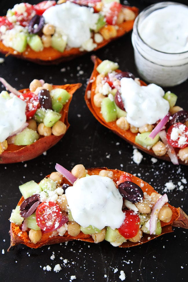 Greek Stuffed Sweet Potatoes Baked sweet potatoes topped with chickpeas, tomatoes, cucumber, kalamata olives, red onion, feta cheese, and tzatziki sauce. These loaded sweet potatoes make an easy, healthy, and delicious meal! 