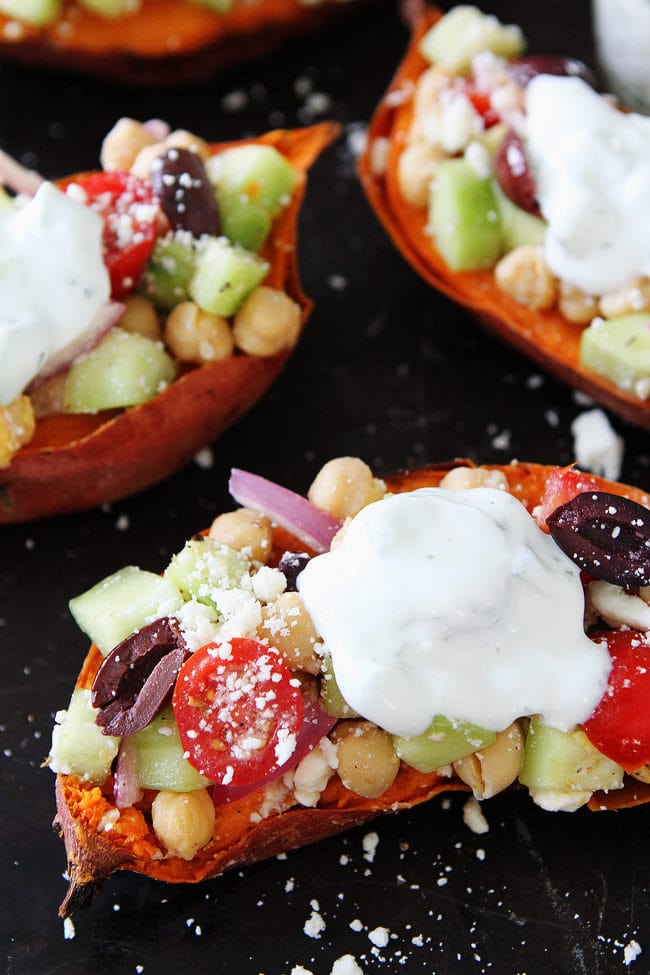 Greek Stuffed Sweet Potatoes Baked sweet potatoes topped with chickpeas, tomatoes, cucumber, kalamata olives, red onion, feta cheese, and tzatziki sauce. These loaded sweet potatoes make a great gluten-free and vegetarian dinner!