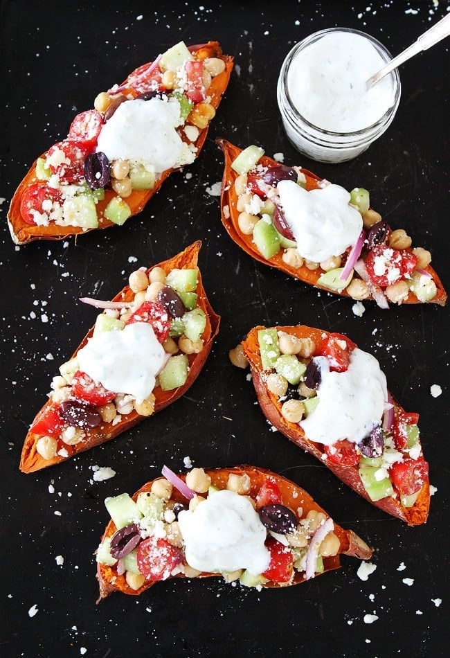 Greek Stuffed Sweet Potatoes Baked sweet potatoes topped with chickpeas, tomatoes, cucumber, kalamata olives, red onion, feta cheese, and tzatziki sauce. These loaded sweet potatoes make an easy and healthy meatless meal. 