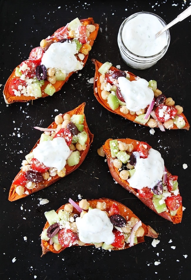 Greek Stuffed Sweet Potatoes Baked sweet potatoes topped with chickpeas, tomatoes, cucumber, kalamata olives, red onion, feta cheese, and tzatziki sauce. These loaded sweet potatoes make an easy and healthy meatless meal. 