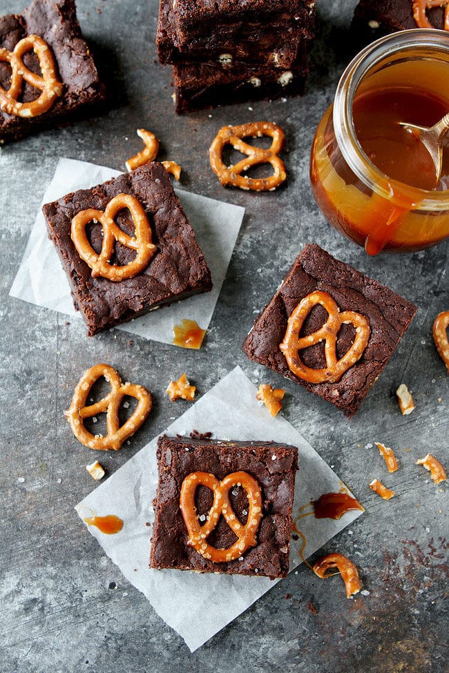 Salted Caramel Pretzel Brownies are fudgy, gooey brownies with pretzel pieces and a layer of salted caramel sauce. These brownies are a great potluck and party dessert!