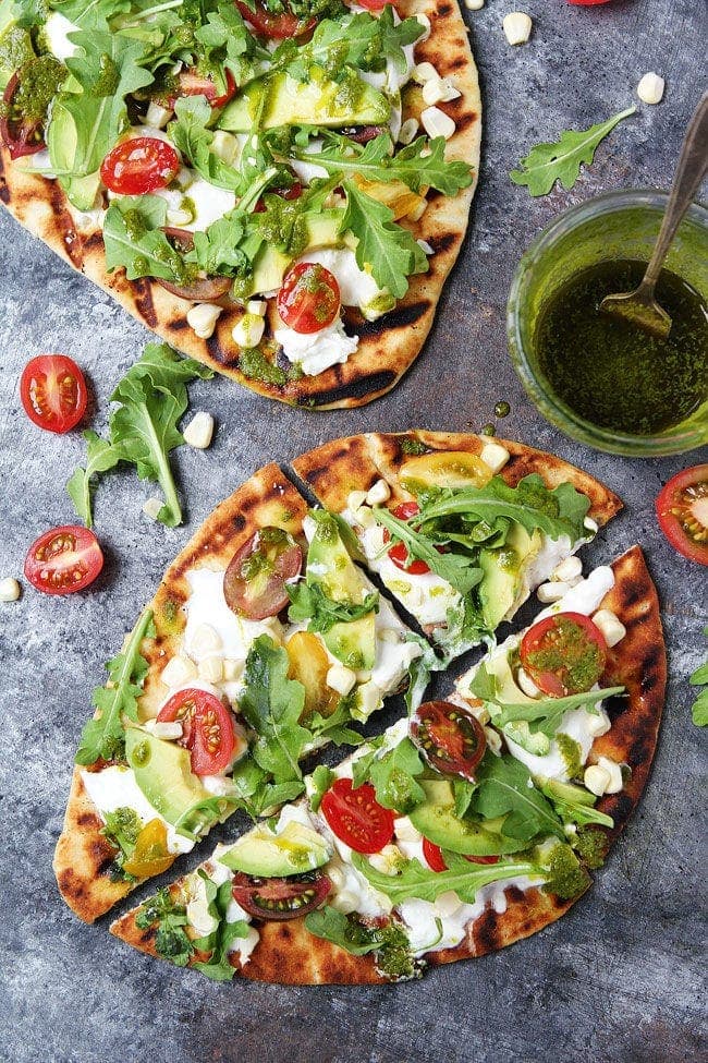 Grilled Flatbread Pizza with tomato, avocado, burrata, and basil vinaigrette