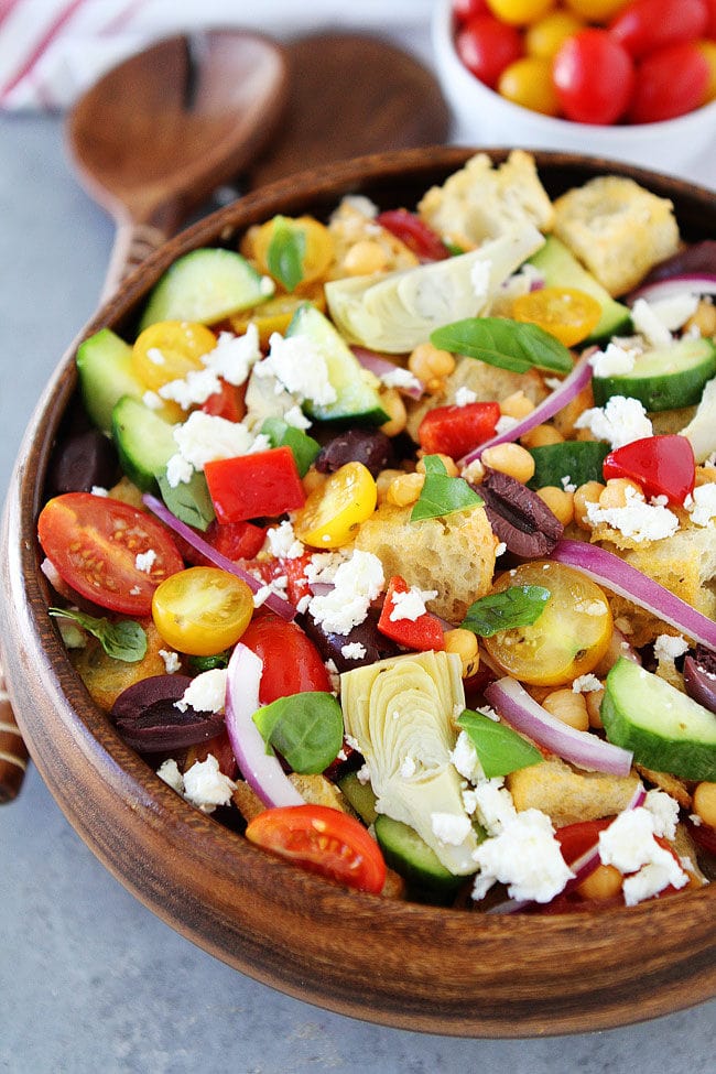 Greek Panzanella Salad made with cubes of crusty bread, tomatoes, cucumbers, chickpeas, artichoke hearts, peppers, olives, red onion, and, feta cheese