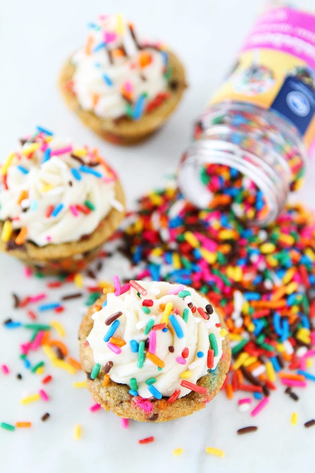 Sprinkle Chocolate Chip Cookie Cups topped with frosting are a fun and delicious dessert for any occasion! Kids and adults love these easy cookie cups!
