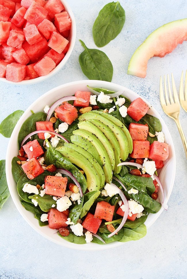 Watermelon Avocado Spinach Salad with feta, almonds, red onion, and poppy seed dressing is the best summer salad! 