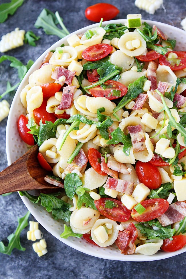 Easy Pasta Salad recipe with bacon, corn, tomatoes, cheese, and arugula. This pasta salad recipe is a family favorite!