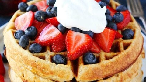 Belgian Waffles stacked with strawberries, blueberries and cream