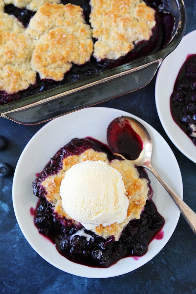 Blueberry Cobbler with ice cream on plate with spoon.