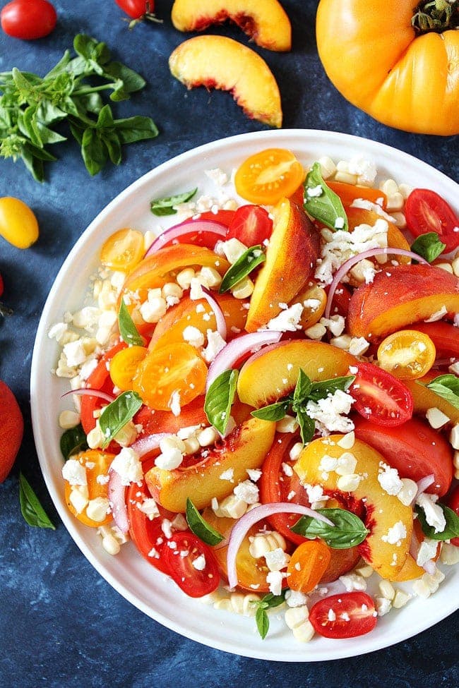 Tomato Peach Corn Salad is a quick and easy summer salad. Perfect side dish for BBQ's, potlucks, and picnics.