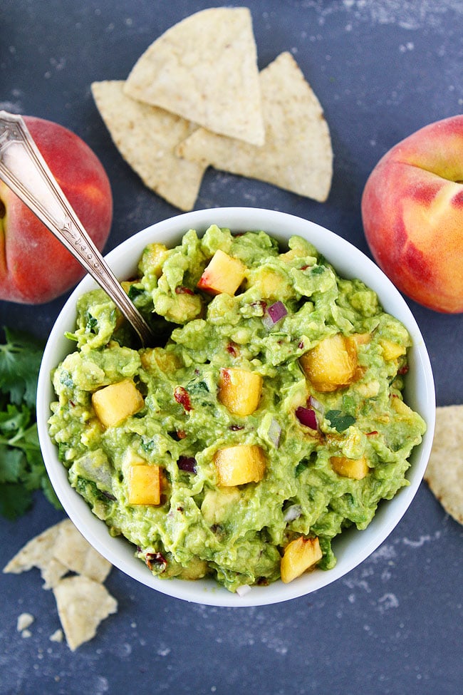 Peach Guacamole with chipotle peppers. This easy guacamole recipe is the perfect summer appetizer or snack.