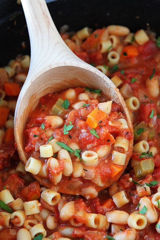 Pasta Fagioli in a wooden ladle.