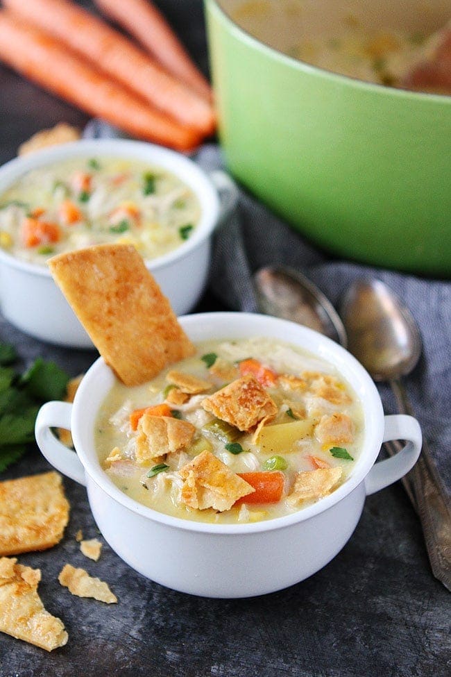 Chicken Pot Pie Soup in bowl with pie crust crackers. 