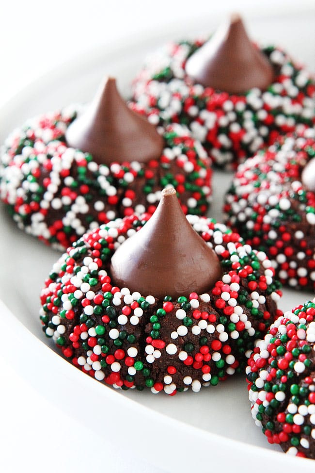 Chocolate Kiss Cookies-decadent chocolate cookies rolled in sprinkles and topped with a chocolate kiss. A fun cookie for the holidays or any occasion! #cookies #Christmascookies #chocolate #dessert #sprinkles 