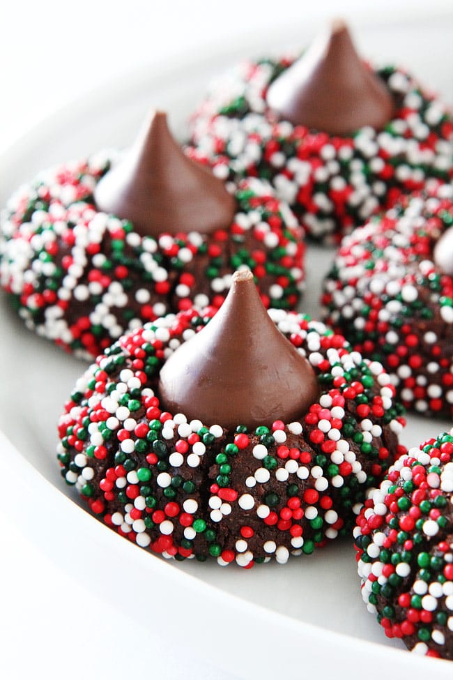 Chocolate Kiss Cookies-decadent chocolate cookies rolled in sprinkles and topped with a chocolate kiss. A fun cookie for the holidays or any occasion! #cookies #Christmascookies #chocolate #dessert #sprinkles