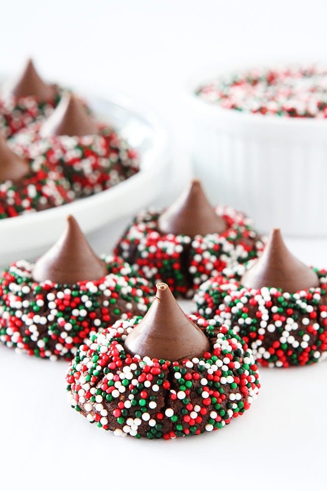 Chocolate Kiss Cookies-decadent chocolate cookies rolled in sprinkles and topped with a chocolate kiss. A fun cookie for the holidays or any occasion! #chocolate #cookies #sprinkles #Christmascookies #holidays 
