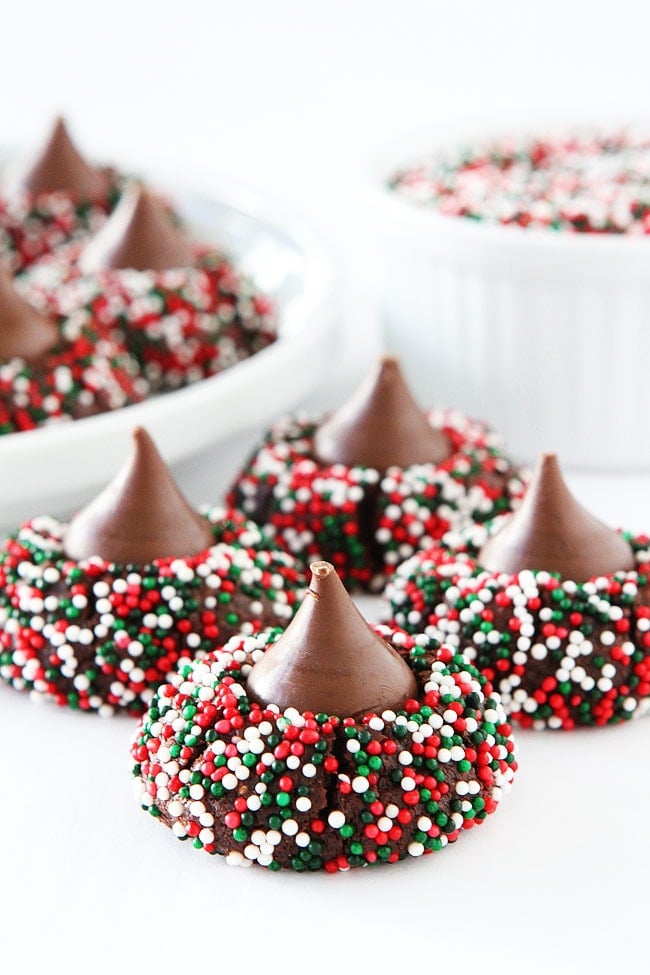 Chocolate Kiss Cookies-decadent chocolate cookies rolled in sprinkles and topped with a chocolate kiss. A fun cookie for the holidays or any occasion! #chocolate #cookies #sprinkles #Christmascookies #holidays