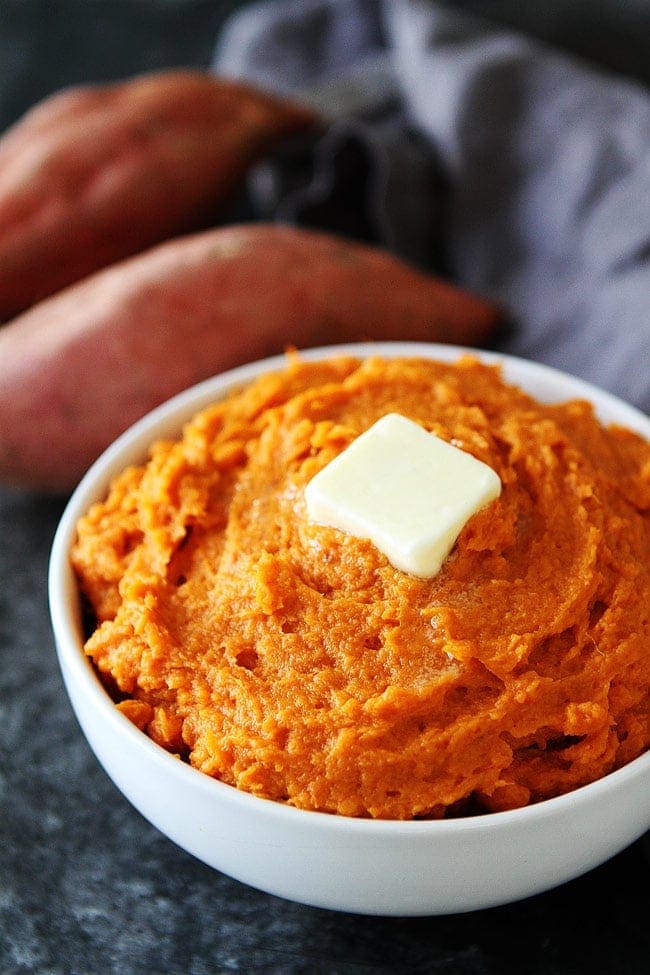 Mashed Sweet Potatoes in bowl with butter.