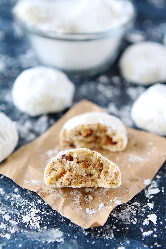 Mexican wedding cookie cut in half with pecans inside. 