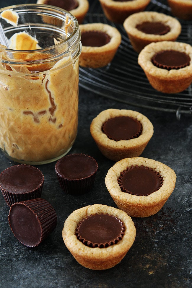 Peanut Butter Cup Cookies with mini peanut butter cups and jar of peanut butter. 