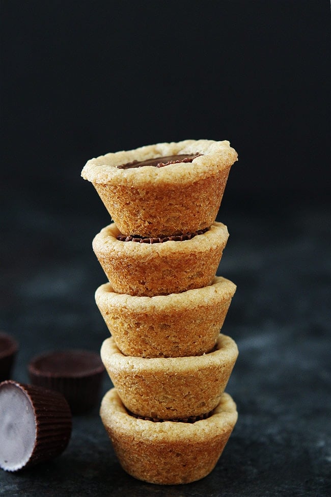 Peanut Butter Cup Cookies-peanut butter cookies made in mini muffin tins with a peanut butter cup in the center. These cookie cups are a family favorite and the perfect cookie for parties and the holidays!