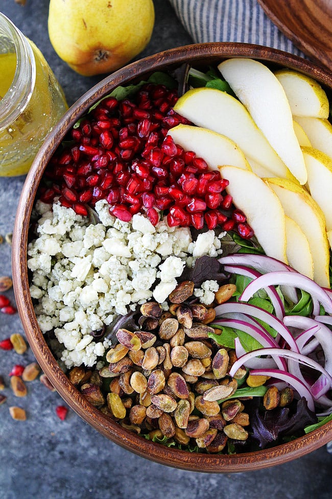 Pear Pomegranate Salad-this fresh green salad with pears, pomegranate, pistachios, red onion, and blue cheese is the perfect salad for your holiday meal. #salad #pear #pomegranate #glutenfree #holidays #Christmas