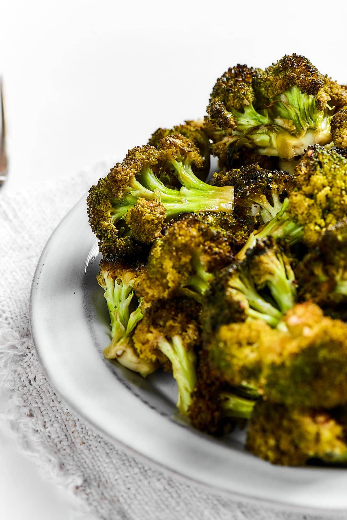 A bowl of roasted broccoli.