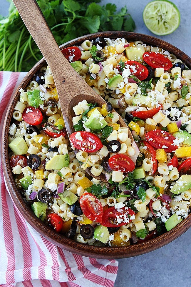 Southwest pasta salad in bowl with wooden spoon. 