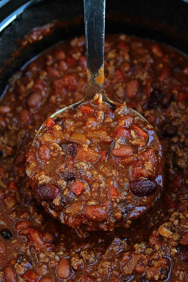 chili in ladle in slow cooker. 