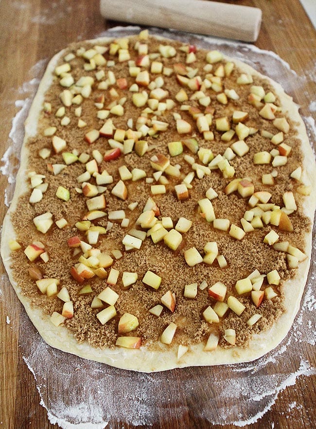 Apple Cinnamon rolls being rolled out on counter