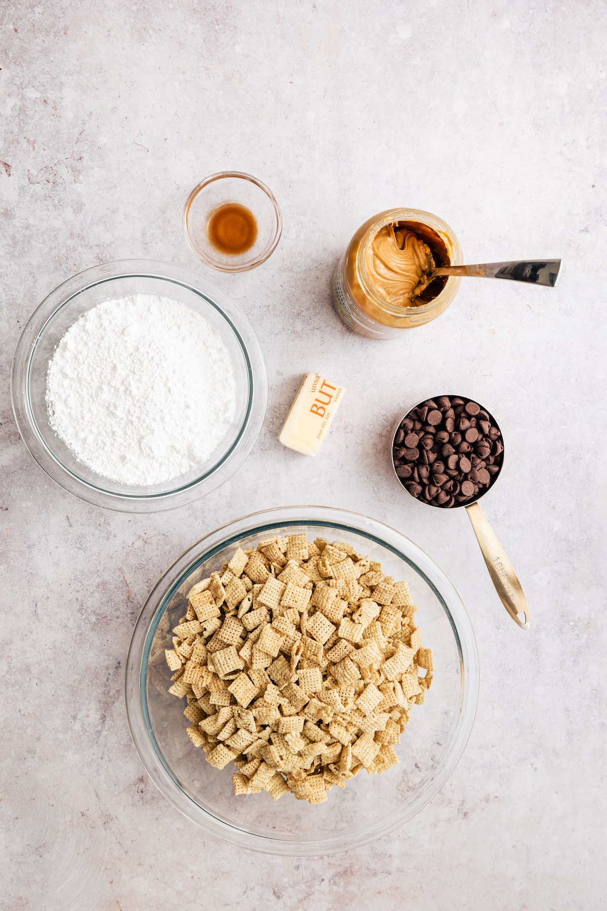 Homemade Puppy Chow is easy to make and SO addicting. This recipe for chocolate peanut butter-covered Chex cereal is a perfect party snack! The ingredients to make homemade puppy chow.