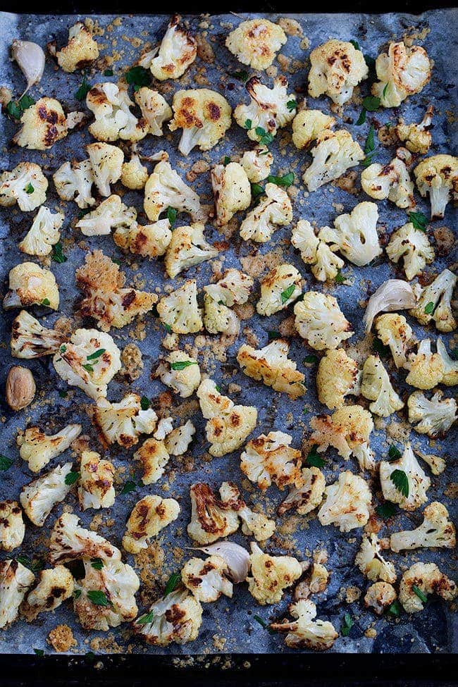 roasted cauliflower with parmesan cheese on baking sheet