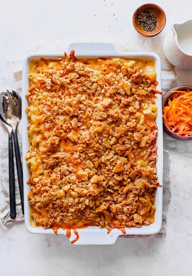 Baked Mac and Cheese with panko cracker topping in white baking dish. 