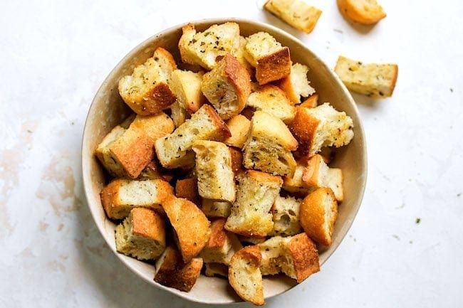 Homemade Croutons in bowl with seasonings. 