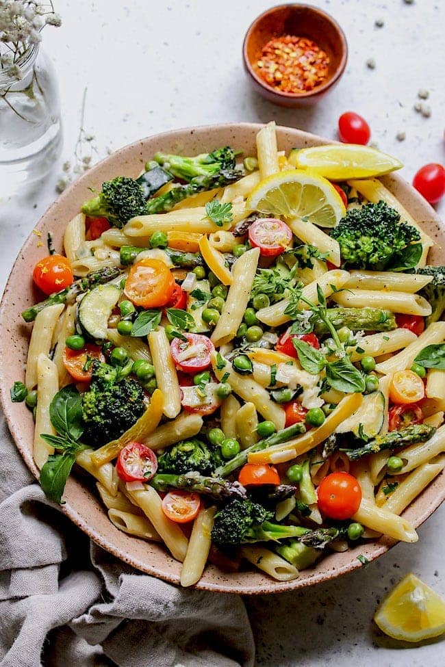 Pasta Primavera with creamy lemon sauce in large serving bowl. 